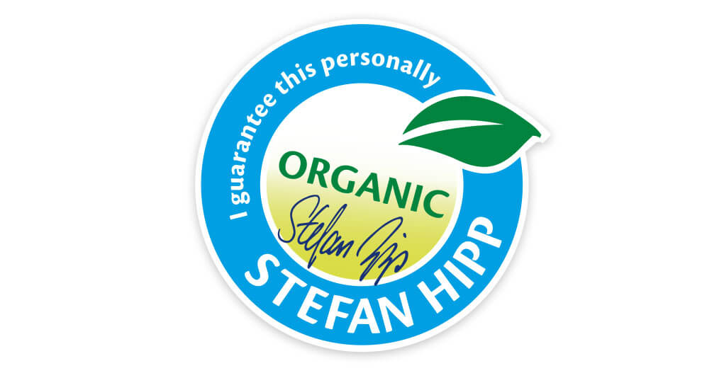 A circular badge with the word "ORGANIC" in the center, a green leaf symbol, and the name "Stefan Hipp" written around the edge.