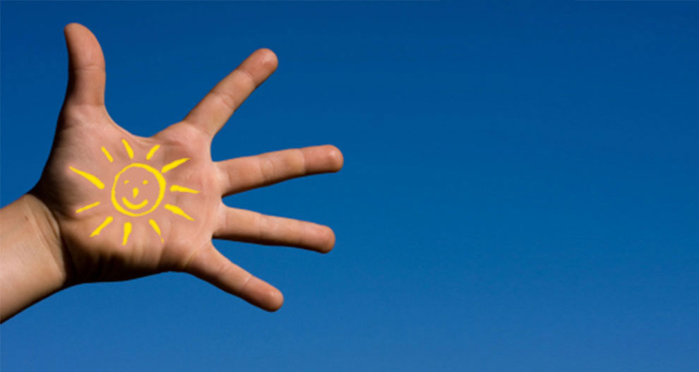 A hand is extended against a blue sky, with a sun drawn on the palm.