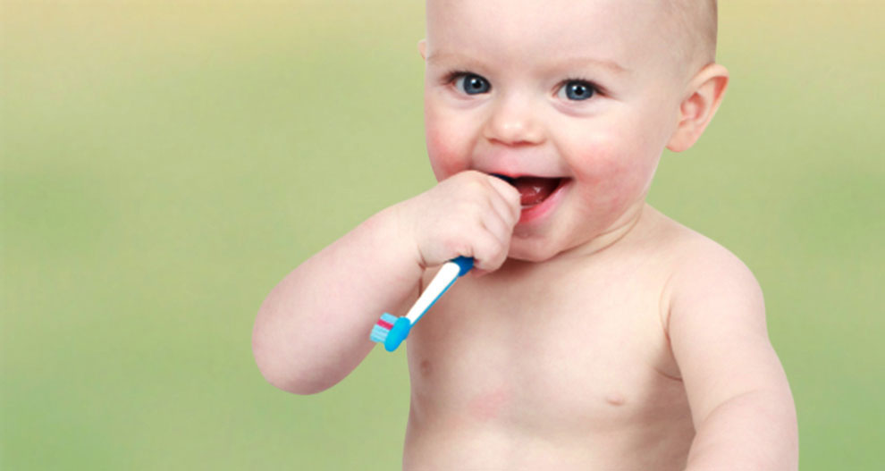 Baby with toothbrush.