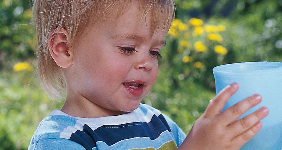 Child drinking from a cup.
